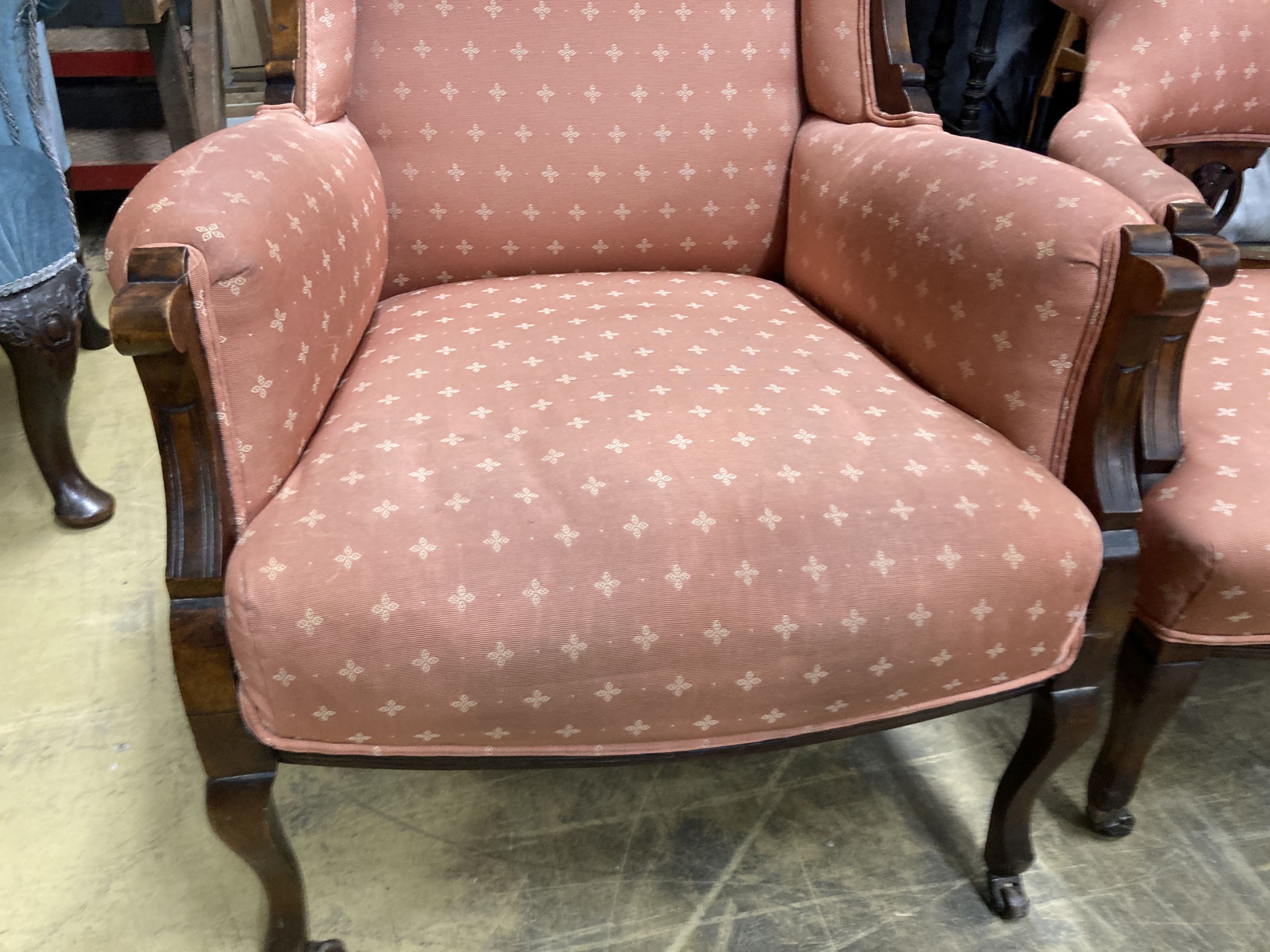 A late Victorian mahogany armchair together with a matching tub framed elbow chair